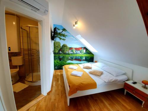 a bedroom with a bed and a painting on the wall at B&B Vila Teslova in Ljubljana