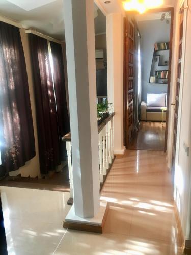 a hallway with a column in a house at Beauty in the Heart of the City in Tbilisi City