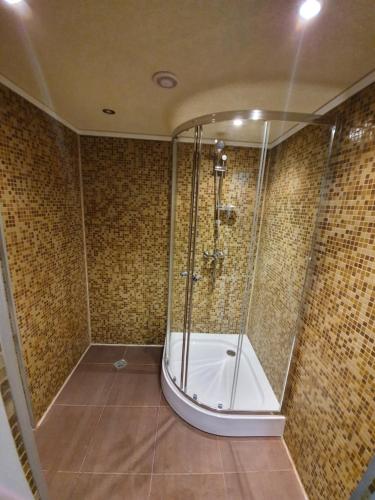 a shower with a glass door in a bathroom at Santa Maria in Burgas City