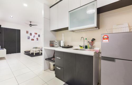 een keuken met een wastafel en een koelkast bij Akademik Suite by JK Home in Johor Bahru