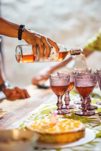 a person pouring wine into glasses on a table at Casa Amberes in Honda
