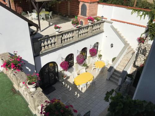 an aerial view of a white building with tables and flowers at U svatého Urbana in Mikulov