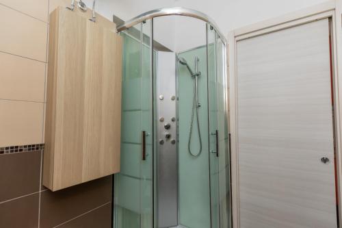een douche met een glazen deur in een badkamer bij Belvedere Naxos 9 in Giardini Naxos