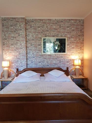 a bedroom with a bed with a brick wall at Agroturystyka u Kasi in Kłodzko
