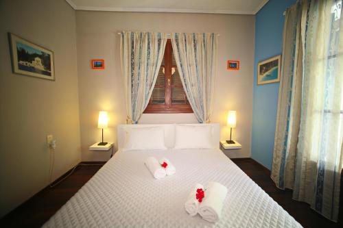 a bedroom with a bed with towels on it at Villa Dimitra Nikiana in Nikiana