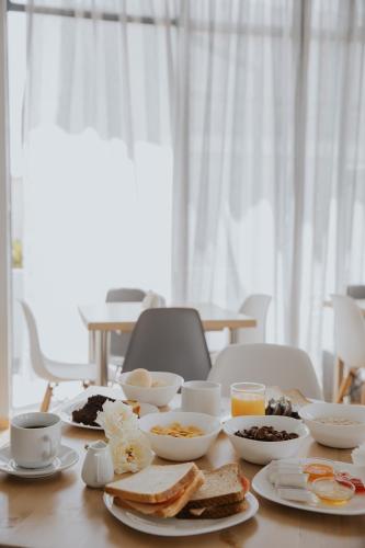 a table topped with bowls of breakfast foods and coffee at Vivari Acta in Vivari