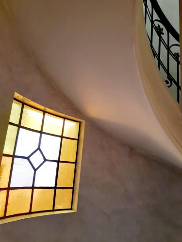 a stained glass window in a stair case at Hotel Benevento in La Plata