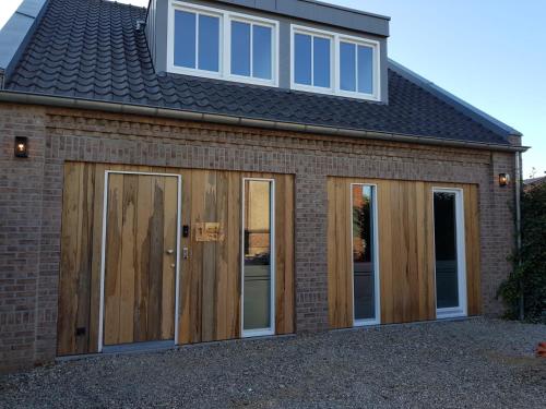 a extension to a house with sliding glass doors at B&B La Vita Verde in Susteren