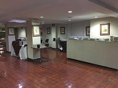 a lobby with a waiting area and a reception desk at Hotel Ambassador in San José