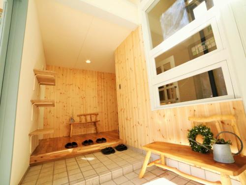 a room with a sauna with a bench and a window at Chillps in Hakuba