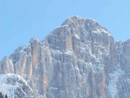 a large rocky mountain with snow on it at B&B Astor in Alleghe