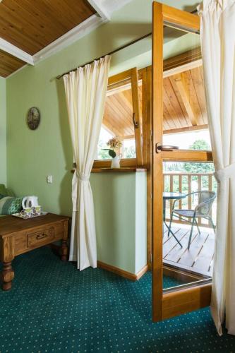 a room with a door open to a patio at Villa Cynamon Jacuzzi & Sauna in Wisła