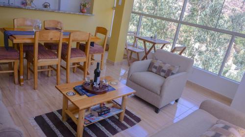 a living room with a table and chairs and a couch at Departamentos Bellavista La Alborada Huaraz in Huaraz