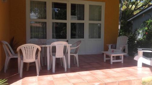 a patio with chairs and a table and a table and chairs at bungalow 3116 vue sur piscine in Las Galeras