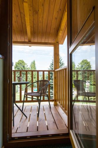 a screened in porch with a table and chairs on it at Villa Cynamon Jacuzzi & Sauna in Wisła