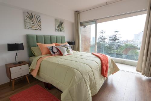 a bedroom with a bed and a large window at GLOBALSTAY - Exclusive Modern Barranco Apartments in Lima