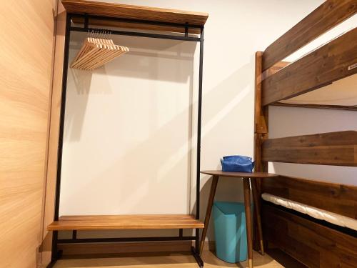 a closet with a glass door and a wooden shelf at Cactus Inn in Miyazaki