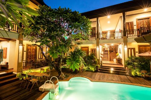 a villa with a swimming pool and a house at Amata Lanna Chiang Mai, One Member of the Secret Retreats in Chiang Mai