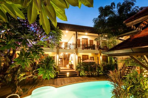 an exterior view of a house with a swimming pool at Amata Lanna Chiang Mai, One Member of the Secret Retreats in Chiang Mai