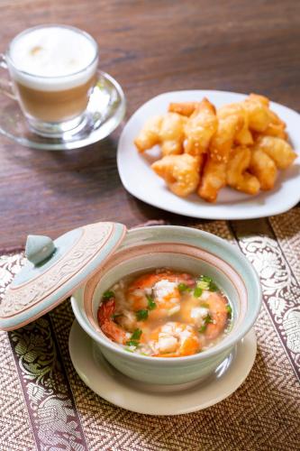 a bowl of food next to a plate of french fries at Amata Lanna Chiang Mai, One Member of the Secret Retreats in Chiang Mai