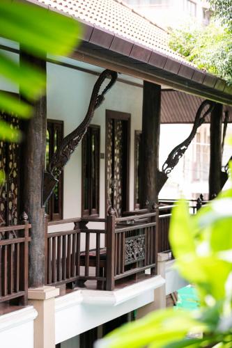 a house with a porch with trees on it at Amata Lanna Chiang Mai, One Member of the Secret Retreats in Chiang Mai