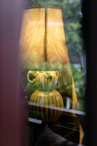 a vase sitting on a table next to a lamp at Amata Lanna Chiang Mai, One Member of the Secret Retreats in Chiang Mai