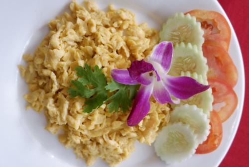 a plate of rice with a purple flower on it at Phi Phi Maiyada Resort in Phi Phi Don