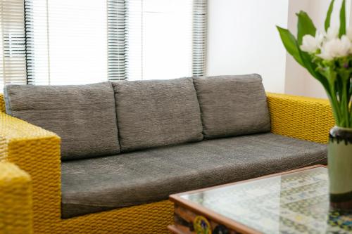 a couch sitting in a living room with a table at Amata Lanna Chiang Mai, One Member of the Secret Retreats in Chiang Mai