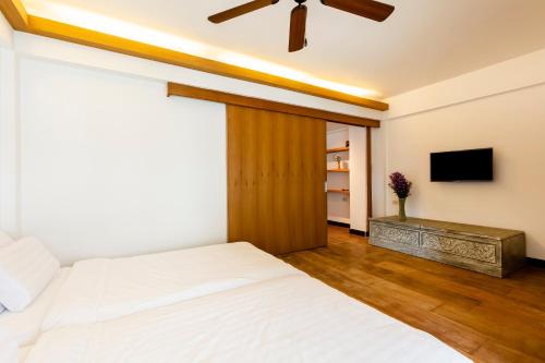 a bedroom with a bed and a ceiling fan at Amata Lanna Chiang Mai, One Member of the Secret Retreats in Chiang Mai