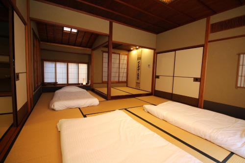 a room with two beds in the middle of it at Nachiya in Kyoto