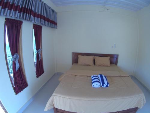 Ένα ή περισσότερα κρεβάτια σε δωμάτιο στο Golo Tango Homestay