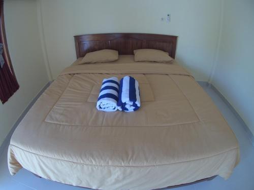 Ένα ή περισσότερα κρεβάτια σε δωμάτιο στο Golo Tango Homestay