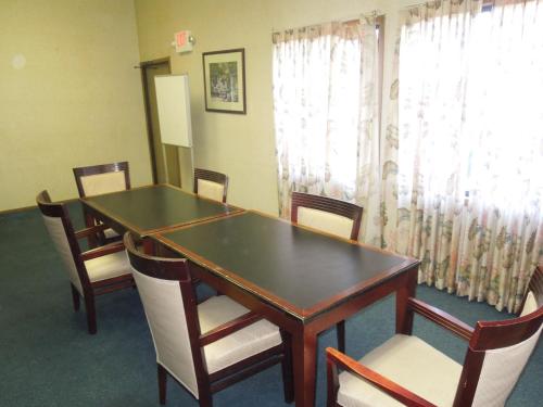 a conference room with a table and chairs and a window at Xenia Country Inn in Xenia
