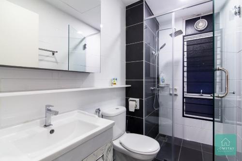 a white bathroom with a toilet and a sink at JOMSTAY Majestic Premier Suites Ipoh Town in Ipoh