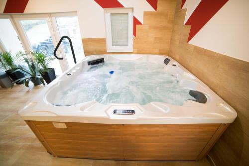 a jacuzzi tub in a living room with at BRILLWELLNESS in Zalakaros