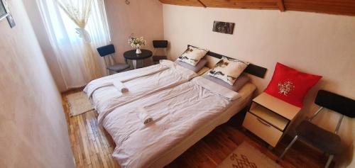 a bedroom with a large white bed with pillows at Villa Vrben in Vrben