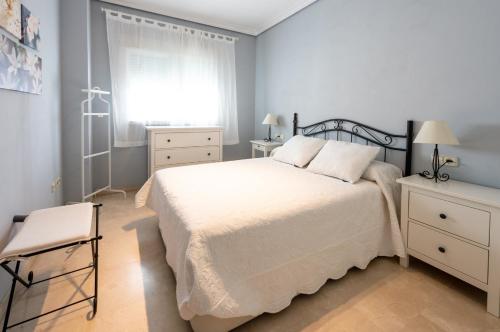 a bedroom with a white bed and a window at Apartamento Nervión Relax and Work (wifi) in Seville