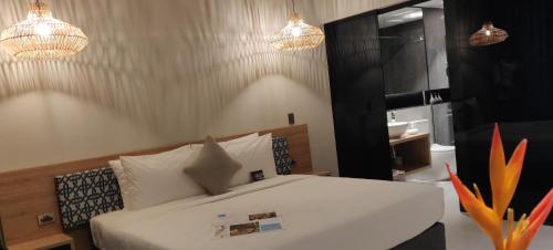 a bedroom with a bed and a sink and lights at Loloata Island Resort in Loloata Island