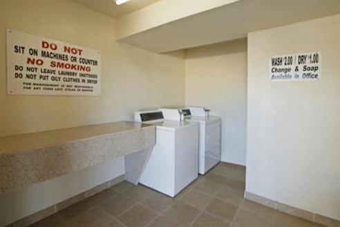 a waiting room with two machines and a sign on the wall at Menifee Inn in Menifee