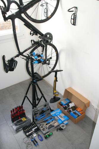 a bike on a stand in a room with tools at Villa Essence - a unique detached villa with A-C, heated private pool, hottub, gardens, patios and stunning views! in Tías