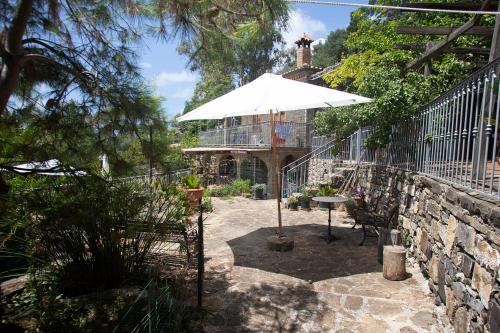 a patio with an umbrella in front of a house at Villa Calamona in Acciaroli