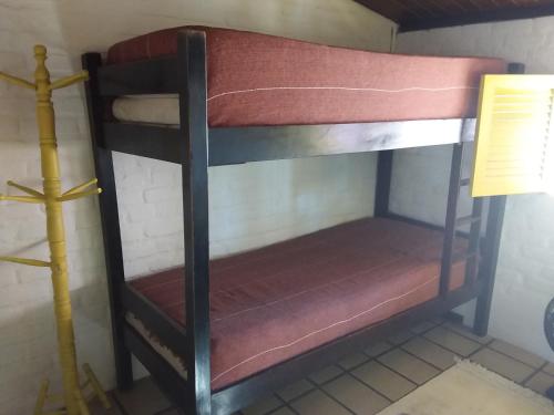 a black bunk bed in a room with a lamp at Otima casa, perto de tudo!! in Porto De Galinhas