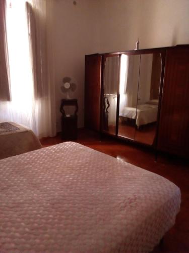 a bedroom with a bed and a large mirror at 3 vani 700 Mt mare e 3000 Mt da Capo D'Orlando in Naso