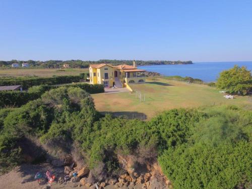 an aerial view of a house on a hill next to the ocean at Sea Breeze Apartment in Korakokhórion