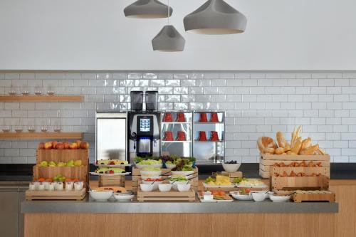 a kitchen with lots of fruits and vegetables on a counter at Vida Creek Harbour in Dubai