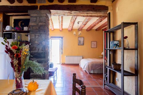 a living room with a table and a bedroom at Casas Arana - Parque Nacional De Ordesa in Albella