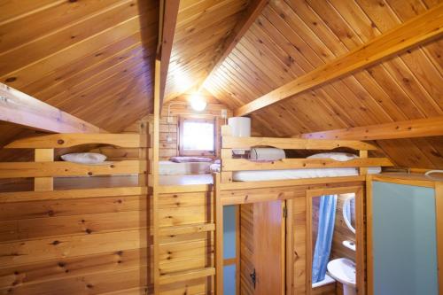 a log cabin with a bathroom and a sink in it at Camping Gironella in Gironella