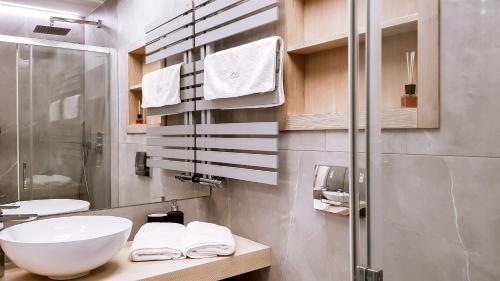 a bathroom with a white sink and a shower at Studio Hrebienok C211 in Vysoke Tatry - Stary Smokovec