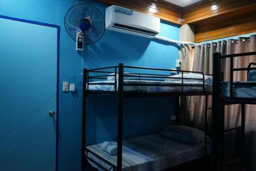 a room with two bunk beds and a fan at Peach Haven in Cebu City