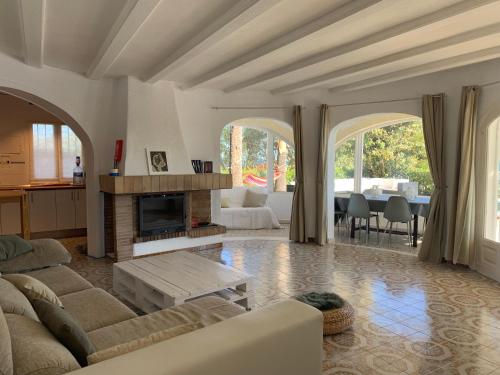 a living room with a couch and a fireplace at Villa Denia Costa Blanca in Denia